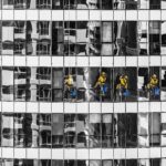 High-rise window cleaners in Dubai cleaning a skyscraper, showcasing urban architecture.